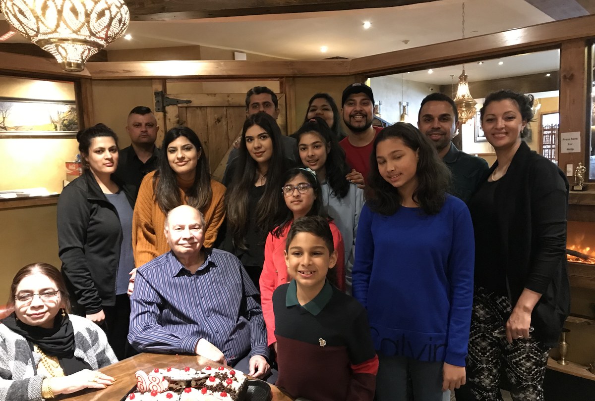 Aslam Hayat surrounded by family at his 85th birthday celebration in Vancouver
