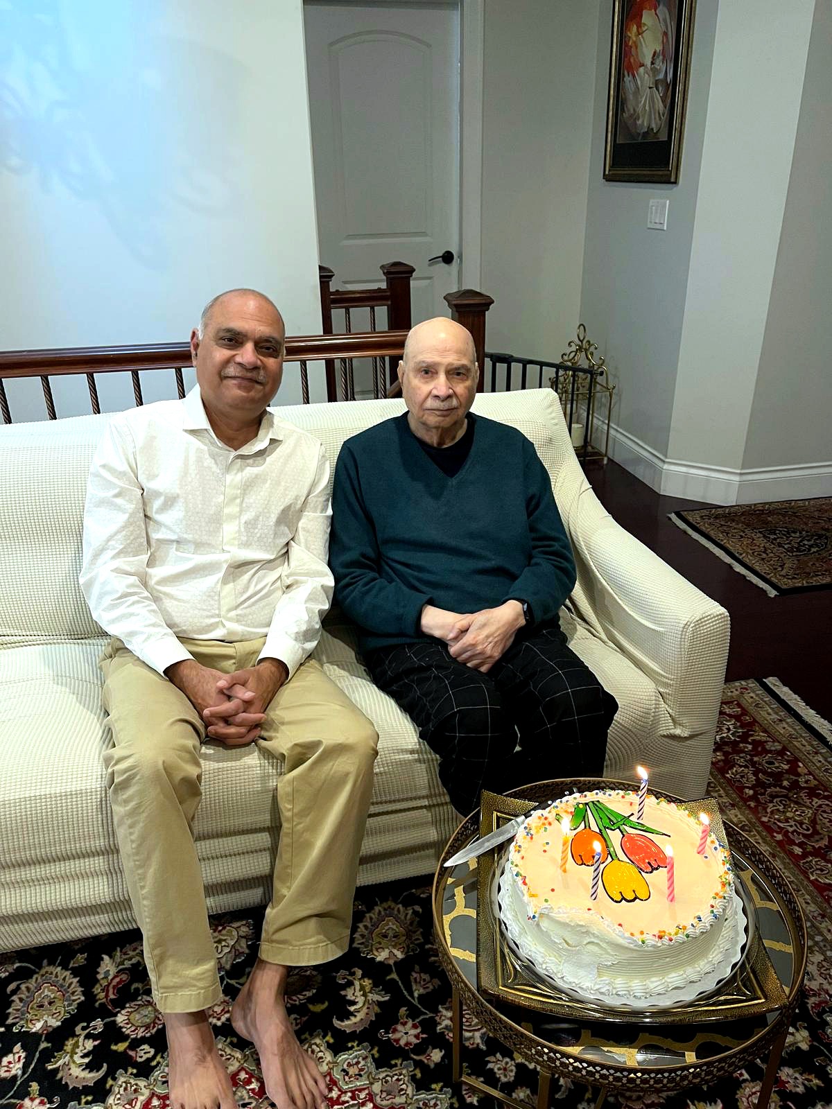 Aslam Hayat on his 93rd birthday seated with son Kamran Hayat, birthday cake in front