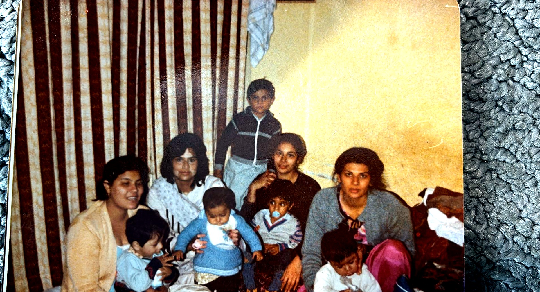 Children and grandchildren of Aslam Hayat gathered together indoors