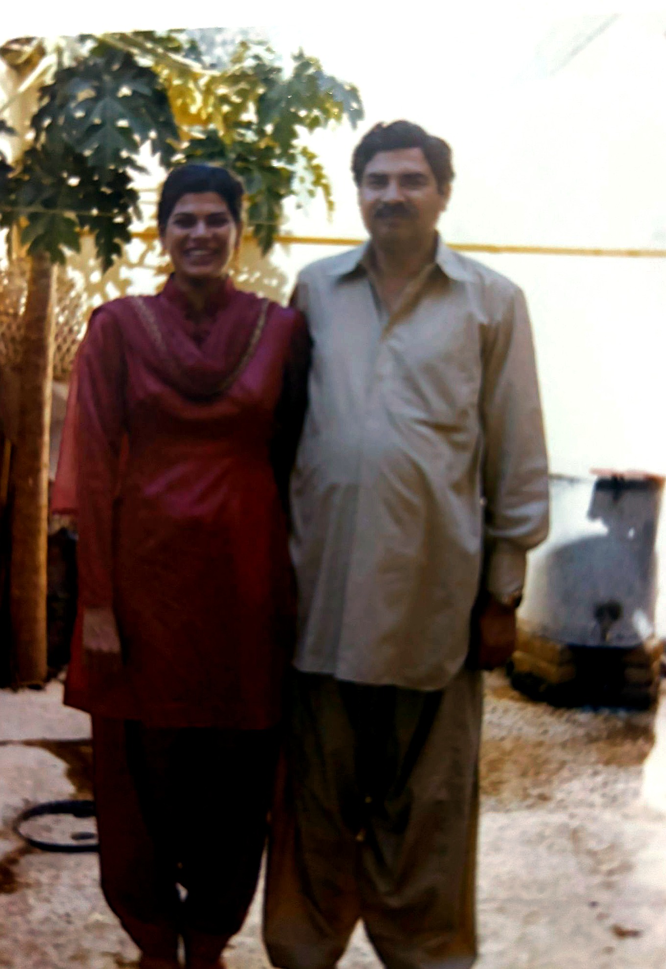 Aslam Hayat with his daughter Aliyia Alam, standing together outdoors in Pakistan